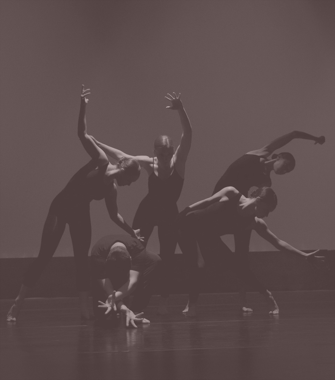 Stylized image showing five dancers staging different poses on theatre stage wearing black clothes